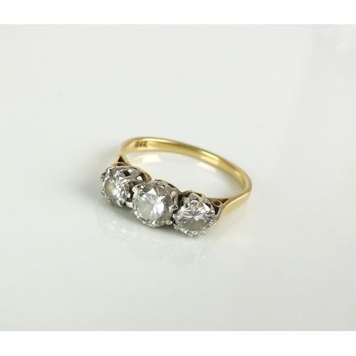 38 - A three stone diamond ring, the three graduated brilliant cut diamonds claw set in white metal to ye... 