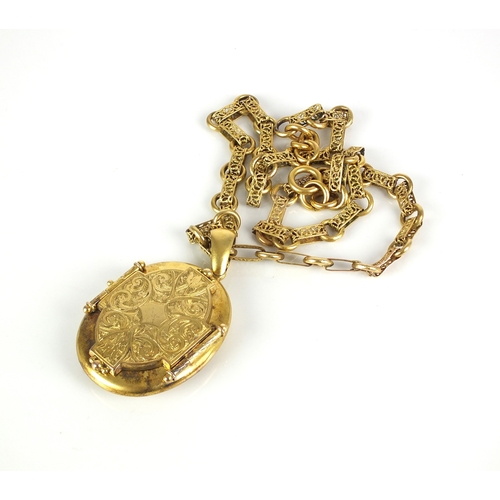 41 - A Victorian yellow metal oval locket suspended from gold decorative link chain, the oval locket with... 