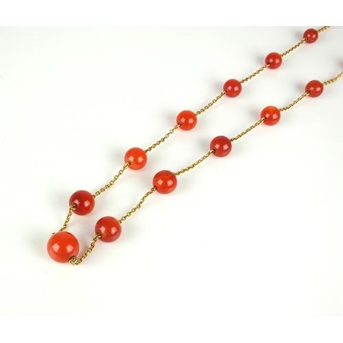 57 - An early 20th century Carnelian bead set chain, the twenty-one graduated spherical beads set to yell... 