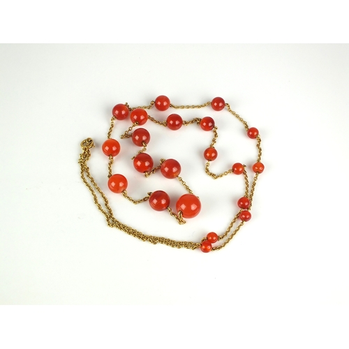 57 - An early 20th century Carnelian bead set chain, the twenty-one graduated spherical beads set to yell... 