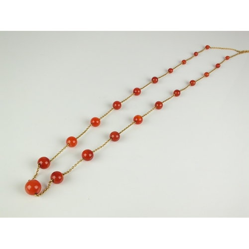 57 - An early 20th century Carnelian bead set chain, the twenty-one graduated spherical beads set to yell... 