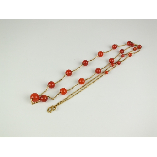 57 - An early 20th century Carnelian bead set chain, the twenty-one graduated spherical beads set to yell... 