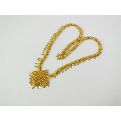 61 - A yellow metal decorative bead and tassel necklace, with diamond shaped plaque pendant, the double s... 