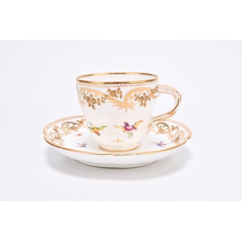 90 - A Coalport coffee cup and saucer, circa 1860, painted by John Randall in his earlier style with smal... 