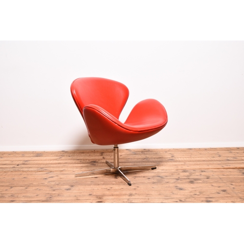 220 - After Arne Jacobsen for Fritz Hansen, a 'Swan' lounge chair Upholstered with red leatherette, mounte... 