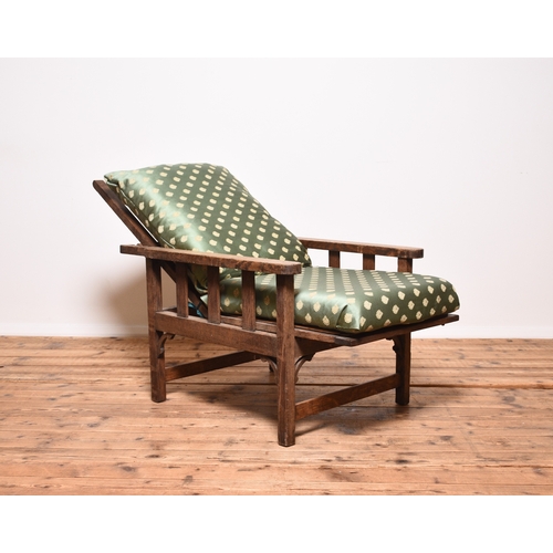 224 - An Arts & Crafts style oak Morris type reclining armchair Circa early 1900s, with loose cushions. 63... 