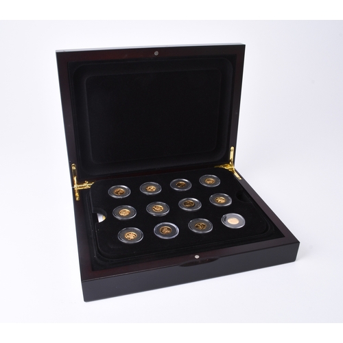 194 - UK Royal Mint. A cased set of twelve 24ct gold foreign coins within capsules and fitted wood case wi... 