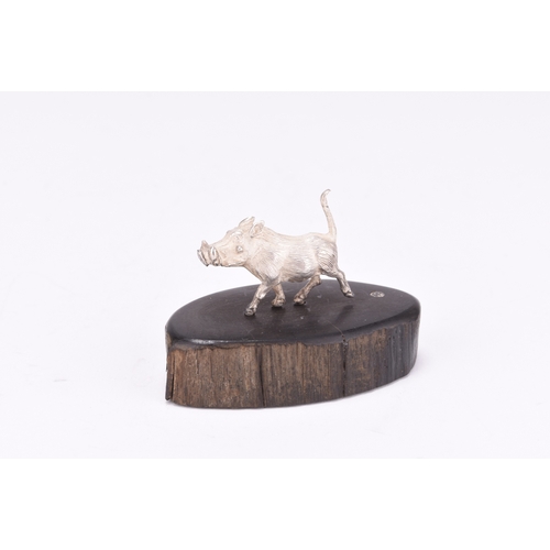 100 - A Patrick Mavros silver model of a Warthog, presented upon wood base, 4.3cm high