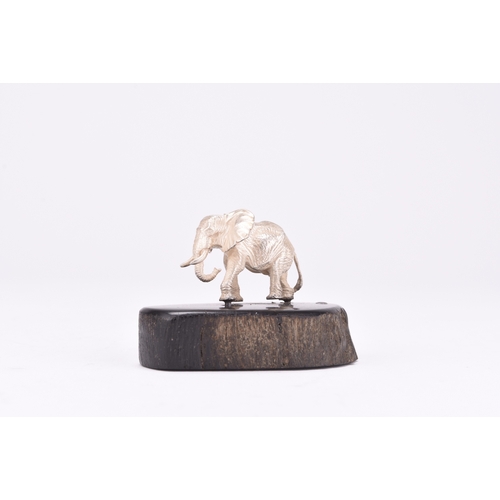 103 - A Patrick Mavros silver model of an elephant, presented upon wood base, 4cm high