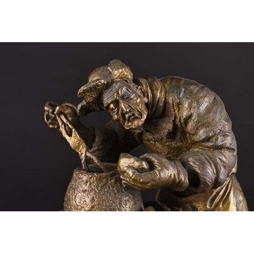 102 - A Chinese bronze alloy figure of a potato vendor, contemporary The aged figure in winter garb at wor... 