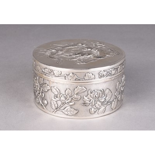 117 - A Chinese silver box and cover by Wang Hing Circa 1900, of circular form, the cover embossed with a ... 