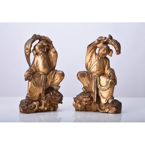 131 - A pair of Chinese gilt wood figures of the twins Hehe Erxian Qing Dynasty, modelled standing on clou... 