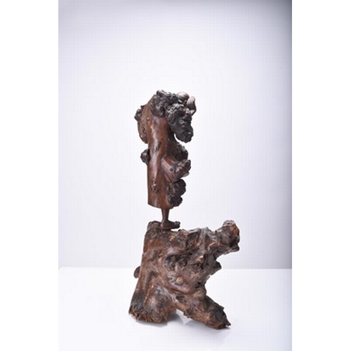 132 - Three Chinese carved wood figures of Luohan, Qing Dynasty The first modelled standing and holding a ... 