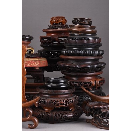 140 - A collection of Chinese carved hardwood vase, plate and curio stands Mainly Qing Dynasty (a lot).