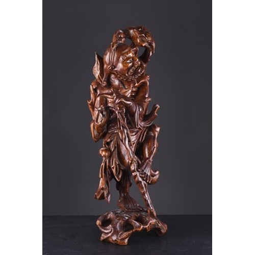 145 - A carved root wood figure of an ascetic Luohan, late 19th century The skeletal figure modelled stand... 