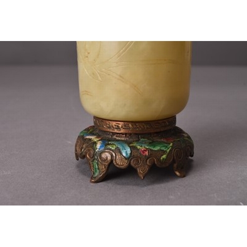 152 - A Chinese nephrite jade and enamelled bronze beaker vase, Qing Dynasty The beaker of pale green hue,... 