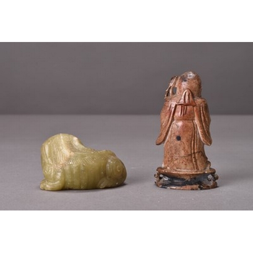 154 - A Chinese jade figure of a lion dog Modelled seated, 7cm, together with a soapstone figure of Shoula... 