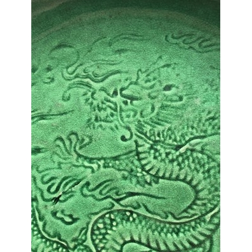 16 - A Chinese Langyao type green glazed dragon dish, probably Kangxi Of plain circular form, the inside ... 