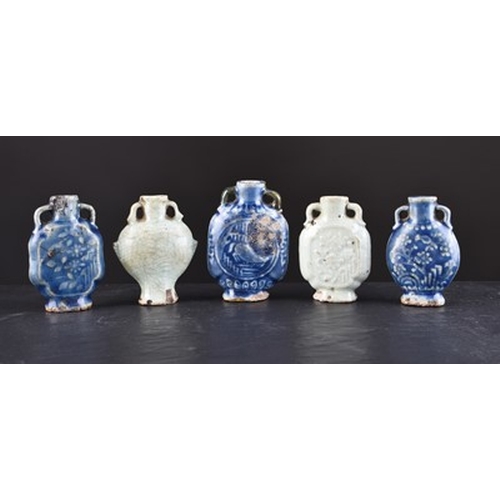 171 - A collection of five Chinese monochrome glazed porcelain snuff bottles Relief moulded with stylised ... 