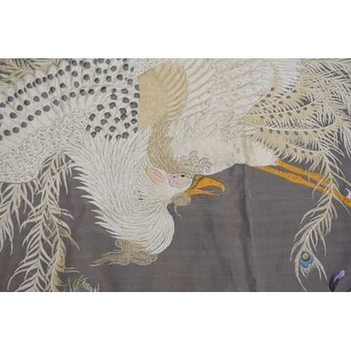 184 - A Chinese embroidered silk bedspread, 20th century Finely woven in coloured threads with a peacock a... 