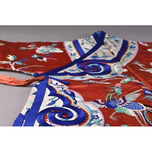 187 - A Chinese silk embroidered child's robe, Qing Dynasty Worked in coloured threads with phoenix birds,... 