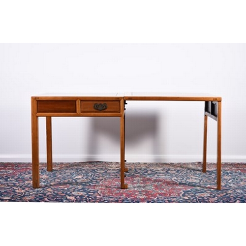 196 - A Chinese mixed wood extending table, 20th century The panelled top above a panelled frieze with two... 