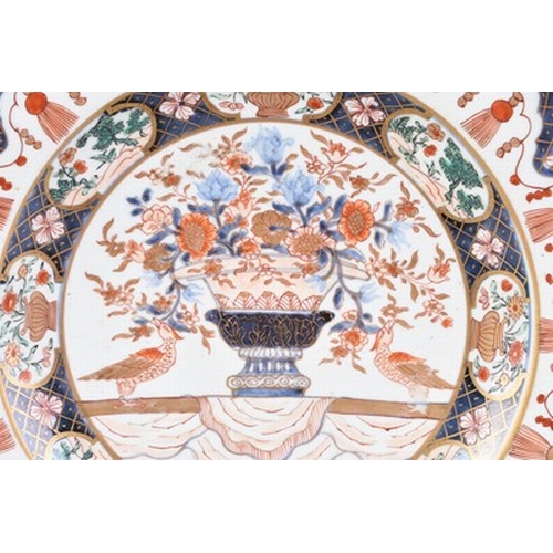 199 - Two Japanese Imari dishes, Edo era Each decorated with a central flower vase, within multiple border... 