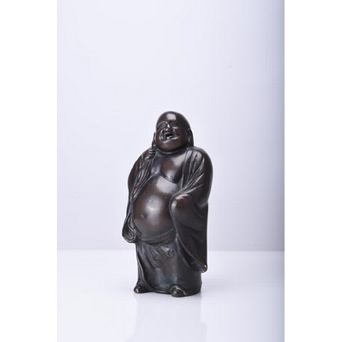 232 - A Japanese bronze figure of Hotei, Meiji era Modelled standing, his robes open at the front, he carr... 