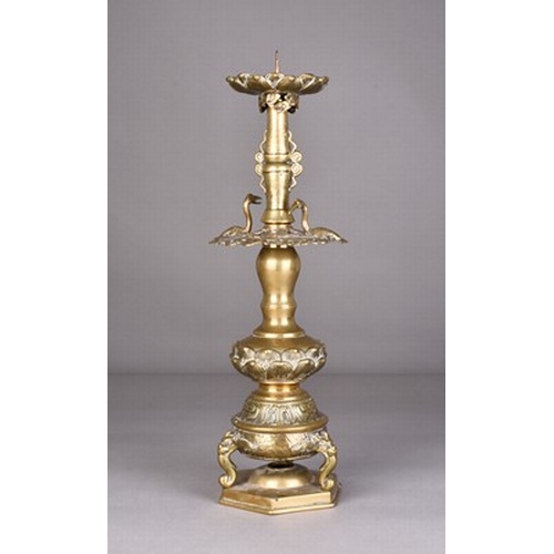 234 - A Japanese bronze candlestick, Meiji era Of three-tiered form and cast with mythical beasts, lotus f... 