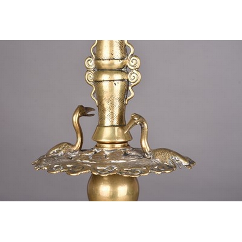 234 - A Japanese bronze candlestick, Meiji era Of three-tiered form and cast with mythical beasts, lotus f... 