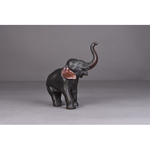 236 - A Japanese bronze figure of an elephant, Meiji era Standing four square with trunk raised in salute.... 