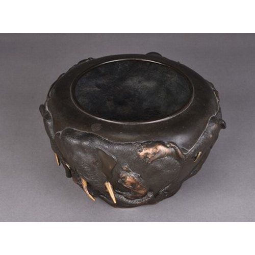 237 - A Japanese bronze planter, Meiji era Of rounded form and cast in relief with a continuous scene of e... 