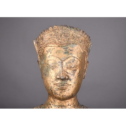 250 - A reproduction Thai gilt alloy Buddha statue fragment On wood stand. 24cm high (37cm on stand)