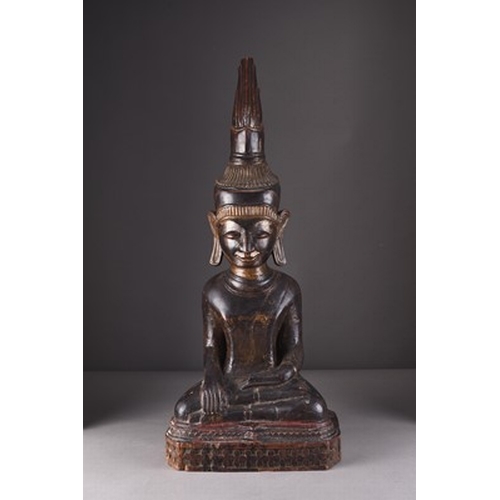 252 - A large South East Asian carved and lacquered wood figure of a seated Buddha, 18th/19th century The ... 