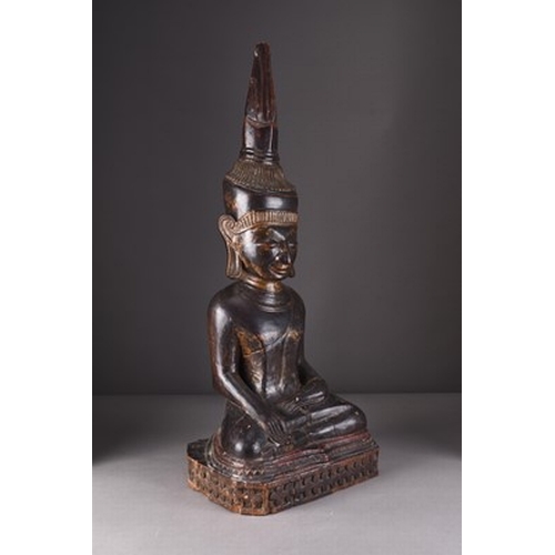 252 - A large South East Asian carved and lacquered wood figure of a seated Buddha, 18th/19th century The ... 