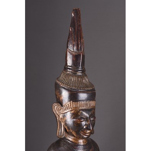 252 - A large South East Asian carved and lacquered wood figure of a seated Buddha, 18th/19th century The ... 