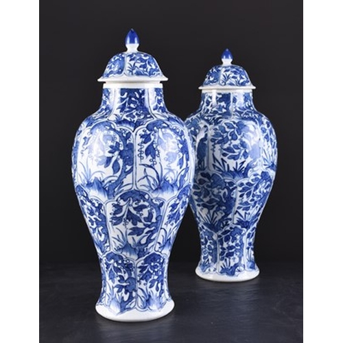 31 - A pair of Chinese transitional blue and white vases and covers, Kangxi Of ovoid form with domed cove... 