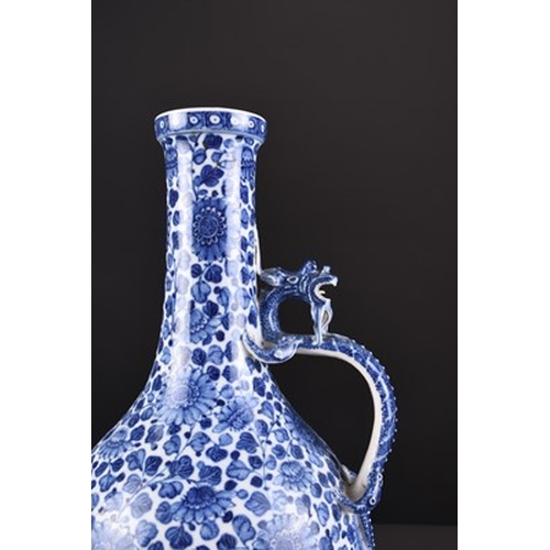 32 - A Chinese soft paste blue and white dragon ewer, 18th century Of bottle form, the handle formed as a... 