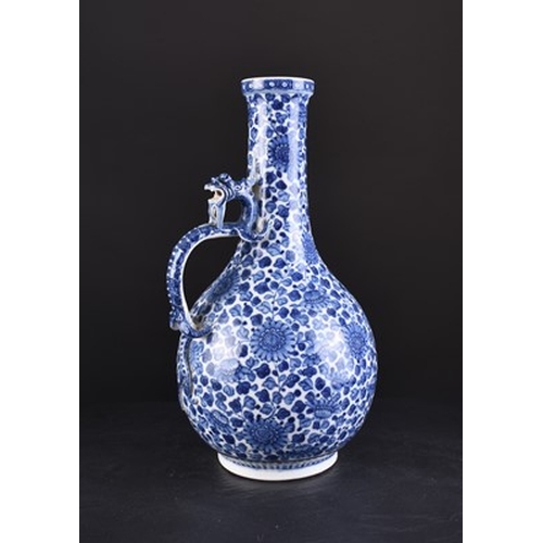 32 - A Chinese soft paste blue and white dragon ewer, 18th century Of bottle form, the handle formed as a... 