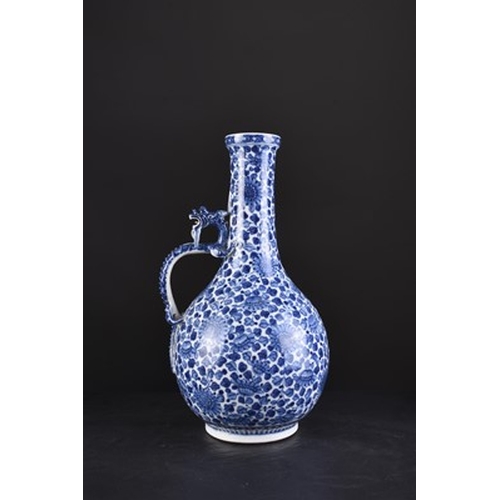 32 - A Chinese soft paste blue and white dragon ewer, 18th century Of bottle form, the handle formed as a... 