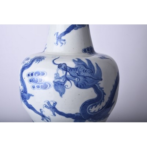 45 - A Chinese blue and white dragon vase, Jiaqing Of baluster form and decorated with three dragons chas... 