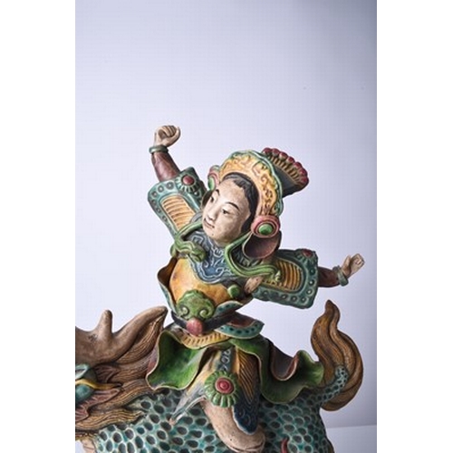 51 - A Chinese Shiwan pottery figural temple tile, Qing Dynasty Modelled as a warrior or immortal riding ... 