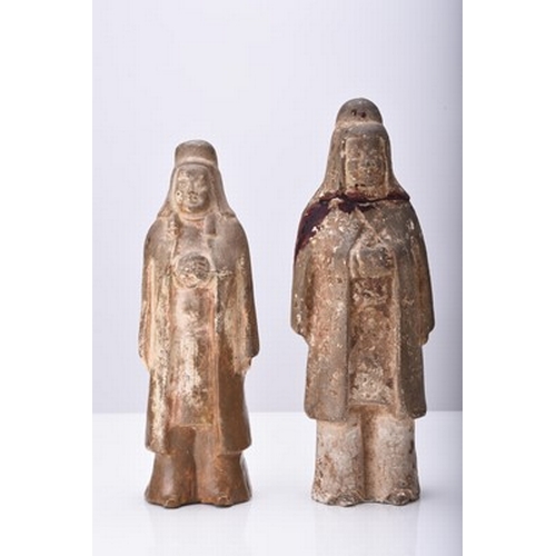 7 - A group of Chinese pottery figures, Tang Dynasty Including: A buff pottery figure of a guardian, mod... 