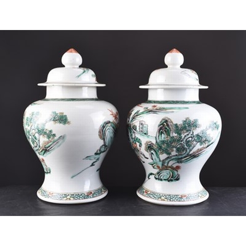 72 - A pair of Chinese famille verte vases and covers, 19th century Of baluster form and decorated with w... 