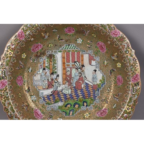 74 - A large Chinese Canton famille rose charger dish, Republic Of cusped form, decorated with a scene of... 