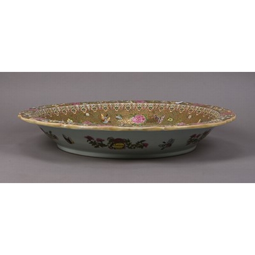 74 - A large Chinese Canton famille rose charger dish, Republic Of cusped form, decorated with a scene of... 