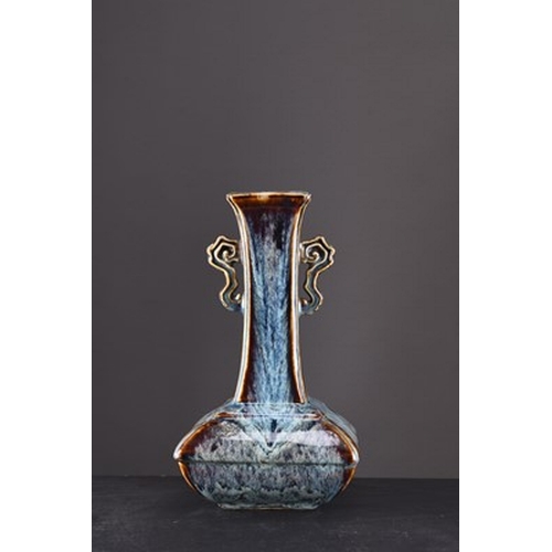 87 - A Shiwan pottery vase, Qing Dynasty Of square section and bottle form, the waisted neck with twin op... 