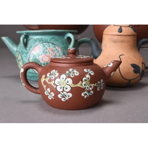 92 - Five Chinese Zisha / Yixing pottery teapots, 20th century Including: A reddish brown pot of compress... 