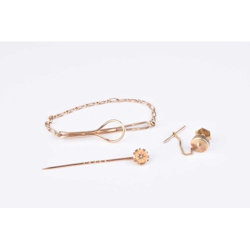 106 - A rose cut diamond set stick pin, stamped '15ct', together with a 9ct gold tie slid, total weight ap... 