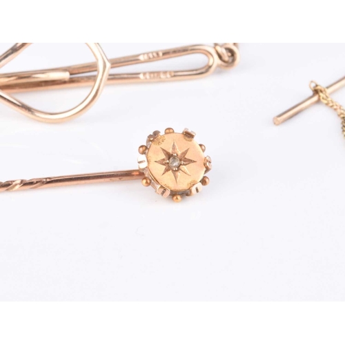 106 - A rose cut diamond set stick pin, stamped '15ct', together with a 9ct gold tie slid, total weight ap... 